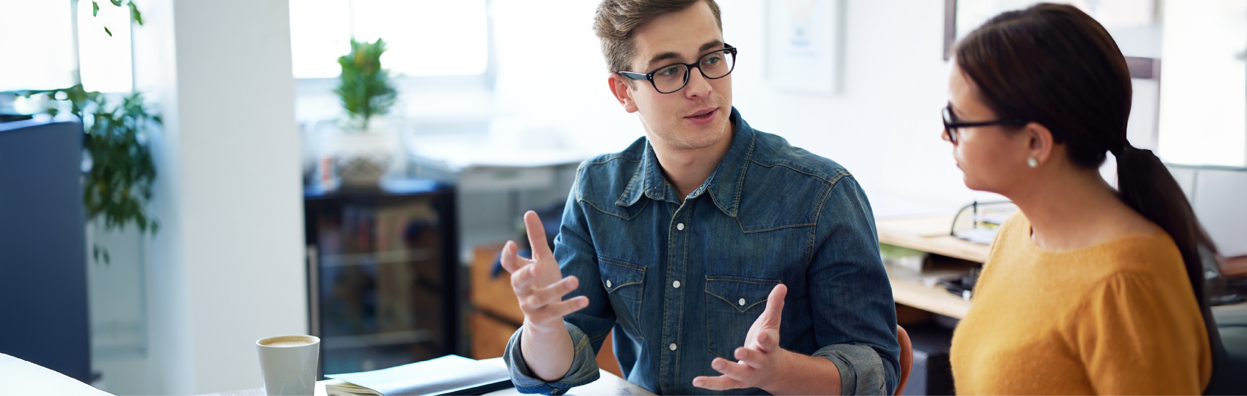 Cropped shot of two coworkers having a discussion in the office
