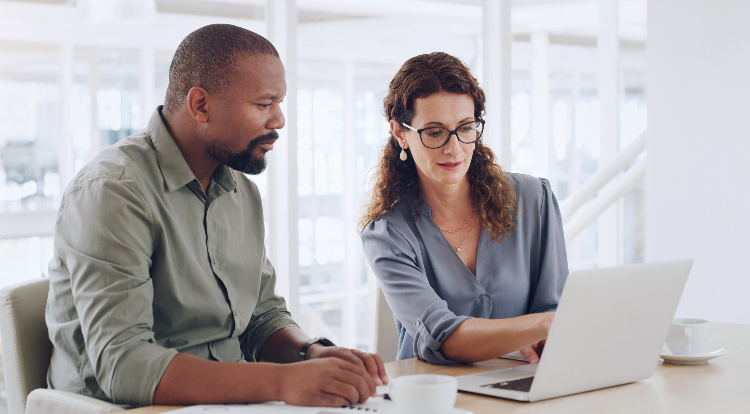 Shot of two businesspeople working together on a laptop in an office
